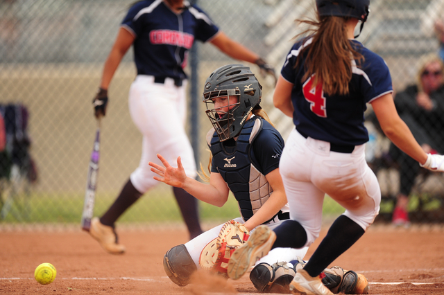 Coronado base runner Dylan Underwood scores a run while Foothill catcher Haleigh Olive field ...