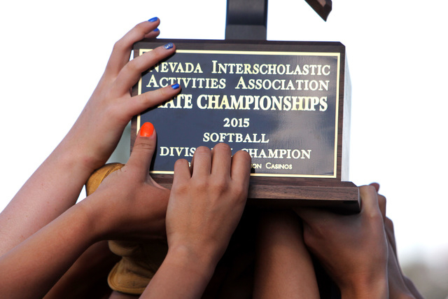 Reed players hoist their trophy aloft after defeating Palo Verde in their Division I champio ...
