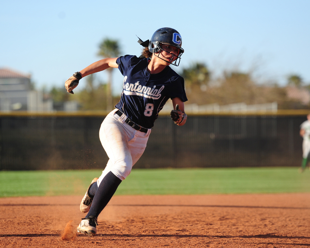 Centennial base runner Angel Love scores a run in the seventh inning of their prep softball ...