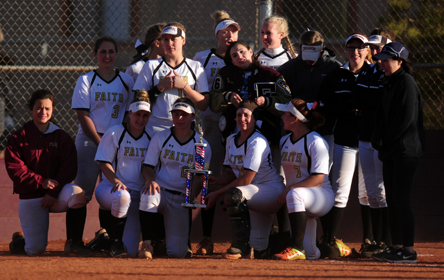 Faith Lutheran players pose with the trophy after defeating Sierra Vista 2-1 in eight inning ...