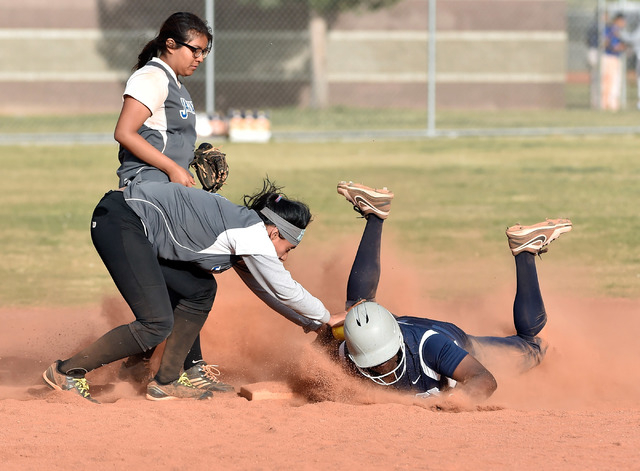 Agassi Prep’s Ayanna McClendon is tagged out at second base by Desert Pines shortstop ...