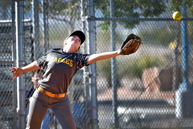 Boulder City third baseman Bryanna Lopez reaches for the ball during a high school softball ...