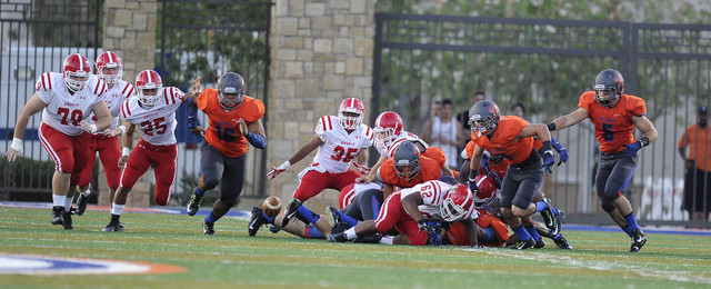 Bishop Gorman players chase after a Brophy Prep fumble on the opening drive of the Sollenber ...