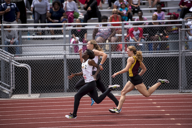 From left, Cayla Nikodemus and Clarissa Mazey, both from Faith Lutheran, edge away from Kelb ...