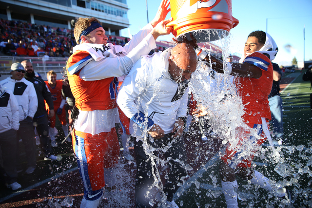 Bishop Gorman’s head football coach Kenny Sanchez, center, gets a Gatorade (water) sho ...