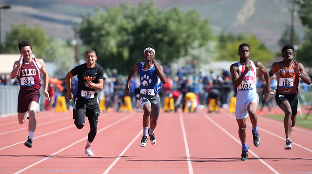 Desert Pines’ Artis McCoy, center, competes in the 1-A Boys 100 at the NIAA track and ...