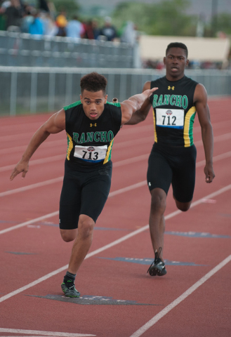 Rancho’s Robert Howard, left, competes in the boys 800 relay during the NIAA Division ...