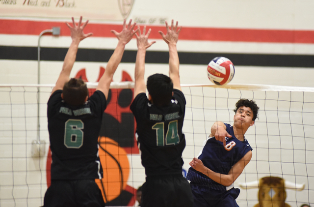 Legacy’s Anthony Guevara (8) spikes the ball against Palo Verde’s Parker Nelson ...