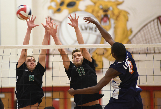 Legacy’s Zaire Franklin (4) spikes the ball against Palo Verde’s Parker Nelson ( ...