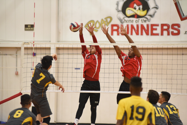 Tech’s Juan Flores (3) and Sir-Issak Singleton (33) try to block a spike by Clark&#821 ...