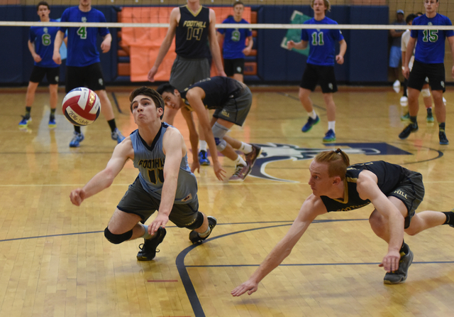Foothill’s Troy Bell (11) and Mason Hanson (2) attempts to dig the ball against Green ...