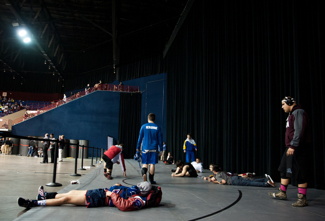 Competitors prepare for their matches, during the state wrestling tournament on Saturday. (M ...