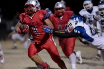 Liberty’s Spencer Wilson (8) runs the ball while Basic’s Mason Hiedeman (44) att ...