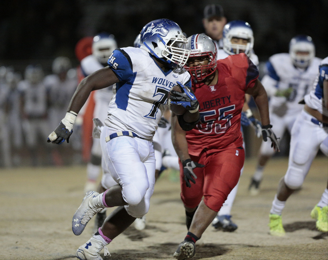 Basic High School’s Kendahl Blakely (7) returns a fumble while being chased by Liberty ...
