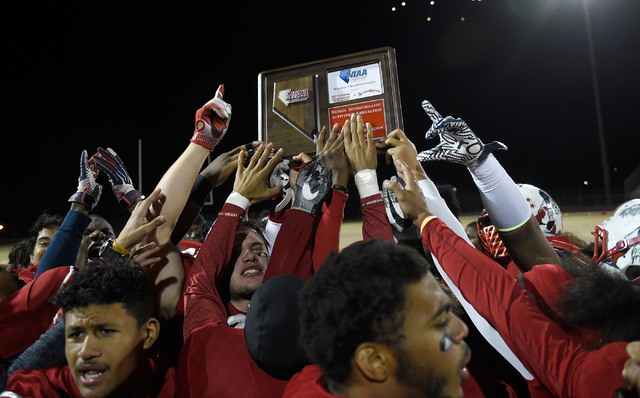 Liberty team members celebrate their 58-14 victory over Basic to win the Sunrise Regional ch ...