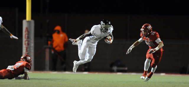 Bishop Gorman halfback Russell Booze (24) is tripped up by Arbor View safety Charles Louch ( ...