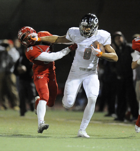 Bishop Gorman tight end Alize Jones (8) avoids a tackle by Arbor View safety Herman Gray (34 ...