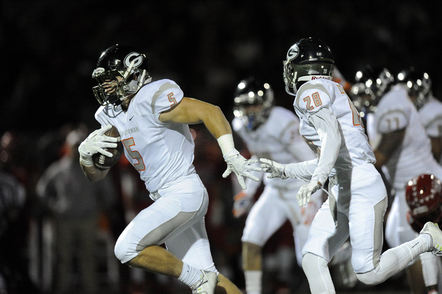 Bishop Gorman Gaels defensive end Ryan Garrett (5) returns an Arbor View fumble 38 yards for ...