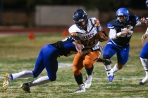 Legacy’s Samuel Turner (22) is tackled by Sierra Vista’s Kevin McCray (46) durin ...