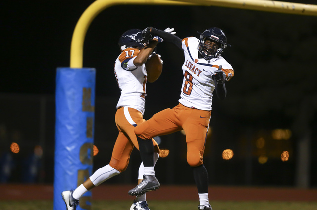 Legacy’s Davick Clark (17) and Marquell Evans (8) celebrate after a touchdown by Clark ...