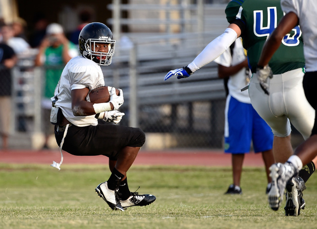 Las Vegas High’s Elijah Hicks runs with the ball during a scrimmage against Green Vall ...