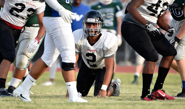 Las Vegas High linebacker Cruz Littlefield lands on his knees during a scrimmage against Gre ...
