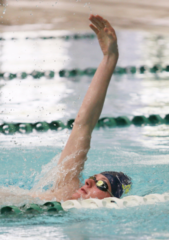 Faith Lutheran senior Bowen Becker, 17, swims the backstroke during a warm-up at practice at ...