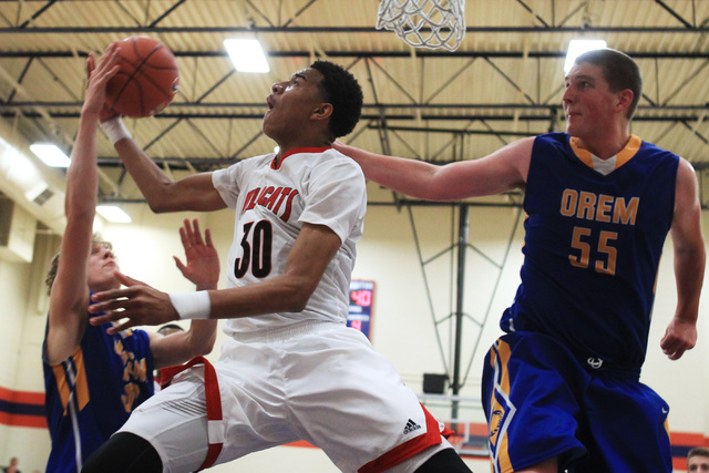 Las Vegas forward Tyler Bey is fouled by Orem forward Noah Johnson and defended by center Ri ...
