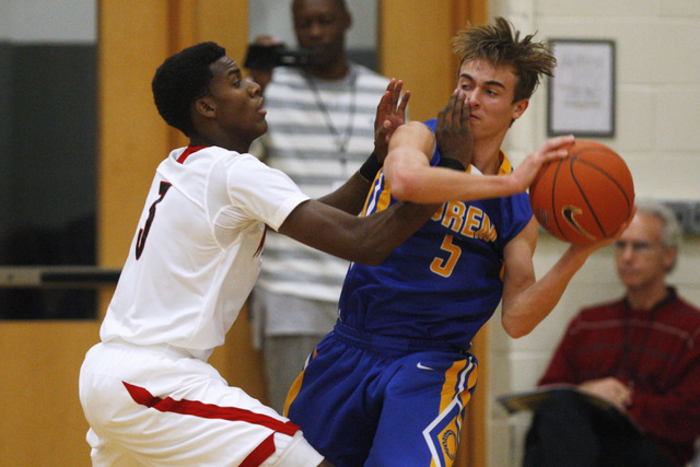 Las Vegas guard Tyshon Raybon gets a hand in the face of Orem guard Jake Stayner at the Tark ...