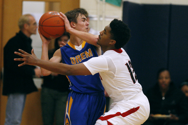 Las Vegas guard Devon Colley defends Orem guard Jake Stayner during their game at the Tarkan ...