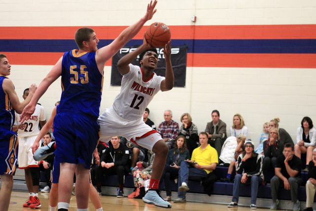 Las Vegas guard Devon Colley drives past Orem center Richard Harward at the Tarkanian Classi ...