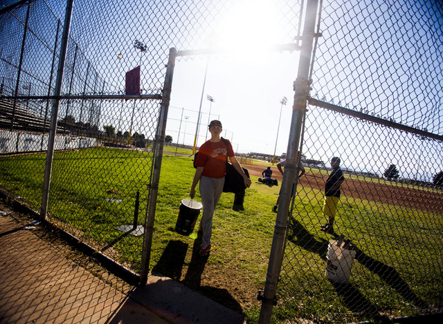 A Tech baseball player carries equipment after practice at the Silver Bowl park baseball fie ...