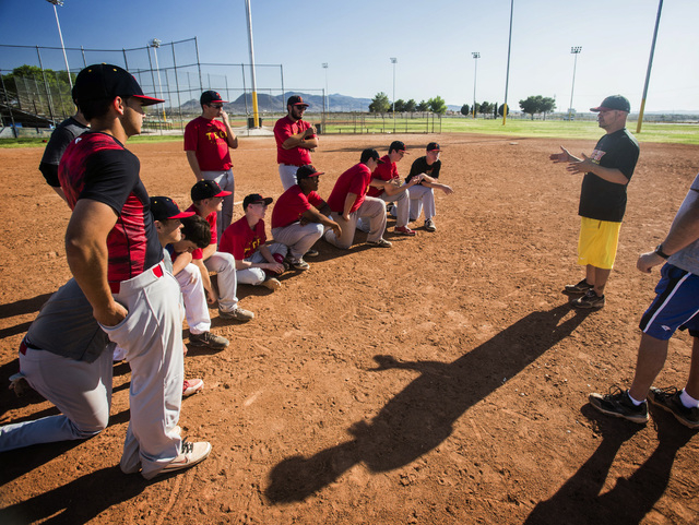Tech baseball coach Bill Stuber, right, talks to his team during practice at the Silver Bowl ...