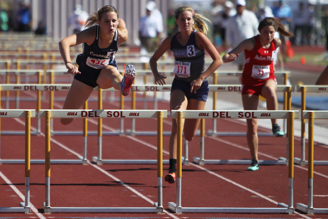 Coronado’s Charleen Jordan leaps over the final hurdle on her way to winning the 100 m ...