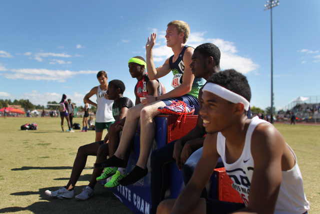 Green Valley sprinter Ian Mack waves from his first place spot on the podium after winning t ...