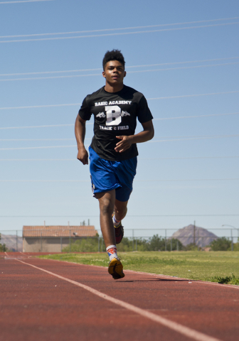 Basic High School high jumper Frank Harris runs warm up laps during track practice at Basic ...