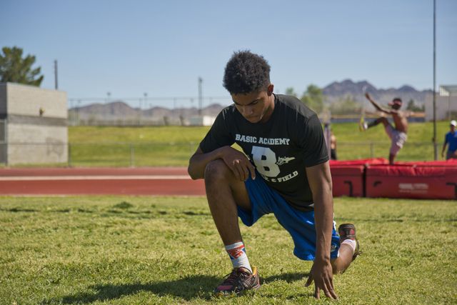 Basic High School high jumper Frank Harris stretches during track practice at Basic High Sch ...