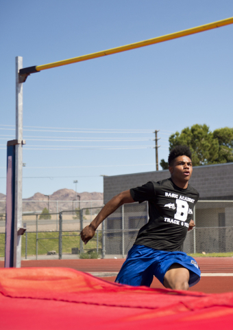 Basic High School high jumper Frank Harris approaches the bar while demonstrating his high j ...