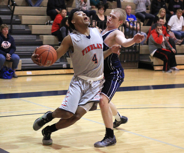 Findlay Prep guard Allonzo Trier is fouled by Westwind guard Jake Jobling during their game ...