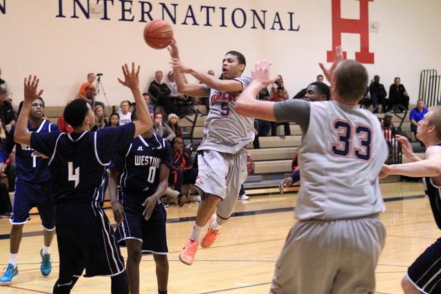 Findlay Prep Derryck Thornton Jr. dishes off a pass against Westwind during their game Tuesd ...