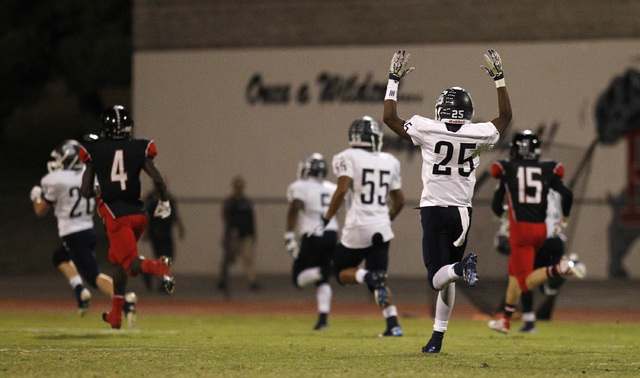 Centennial defender Demetrius Goodman (25) holds his hands up as Tishawn Barnaby (5) scores ...