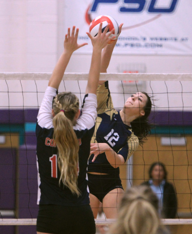 Coronado’s Cali Thompson, left, leaps to block a shot by Foothill’s Rebecca Hill ...