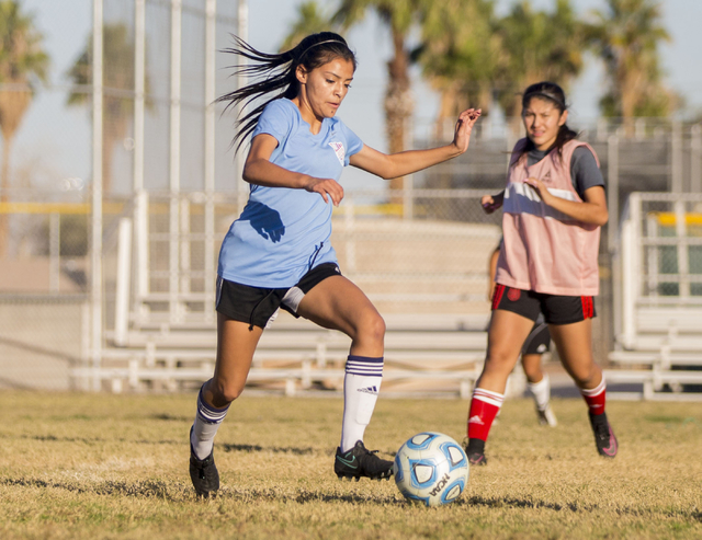 Western Warrior girls soccer midfielder and captain Kirsten Molinaruns, senior, left, run w ...