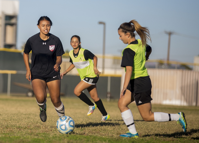 Western Warrior girls soccer midfielder Ellyson Reynada, senior, left, runs with the ball d ...