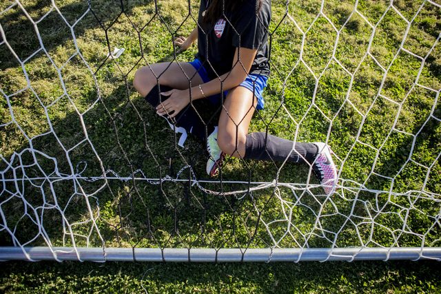 A Western Warriors girls soccer teammate helps set up the net before practice at Western Hig ...