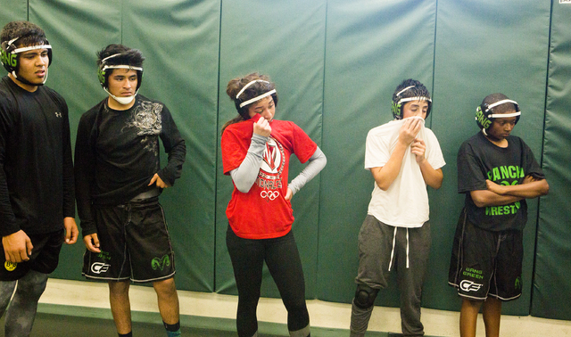 Leiana Nacapuy, in red, a Junior Women’s Freestyle Nationals All-American, wipes swea ...