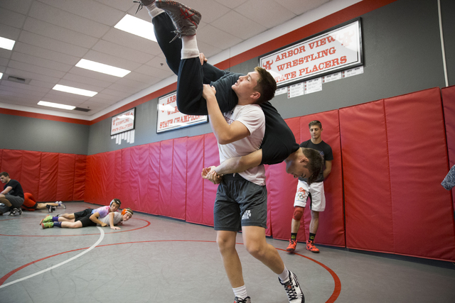 Ryder Marchello, left, 17, lifts Matthew Alejandro, 18, during a wrestling practice at Arbor ...