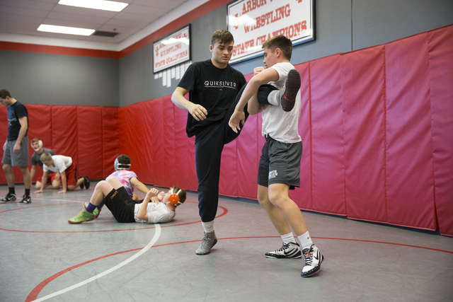 Matthew Alejandro, left, 18, wrestles with Ryder Marchello, 17, during a wrestling practice ...