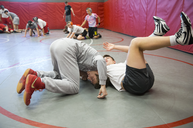 Dawson Downing, left, 17, and Ryder Marchello, 17, wrestle during a team practice at Arbor V ...