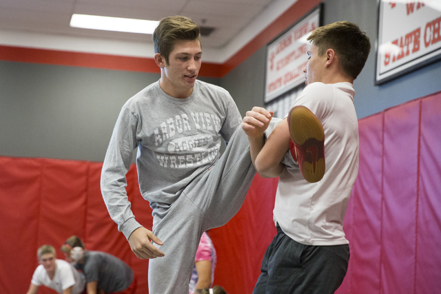 Dawson Downing, left, 17, and Ryder Marchello, 17, wrestle during wrestling practice at Arbo ...
